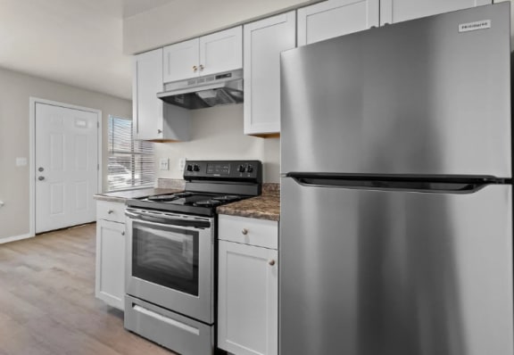 a kitchen with stainless steel appliances and white cabinets at Osage Creek, Arkansas, 72756