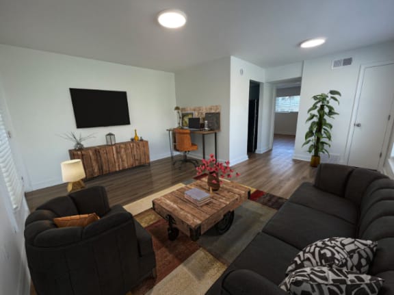 a living room with couches and a coffee table  at The Courts Midtown, Memphis, TN