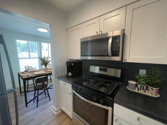 a kitchen with a stove and a microwave at The Courts Midtown, Memphis, TN, 38104