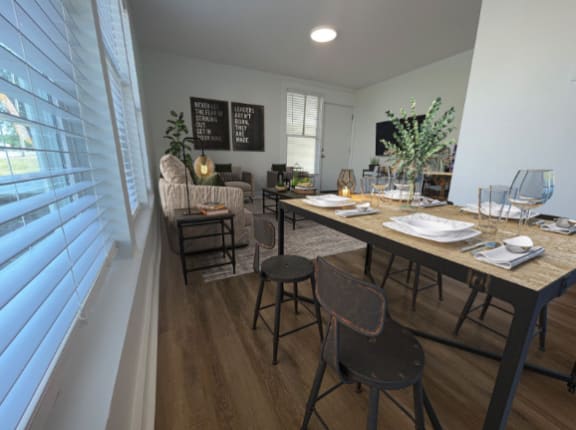a dining room and living room with a table and chairs  living room at The Courts Midtown, Memphis