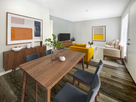 a living room and dining room with a wooden table at The Junction, Memphis, TN