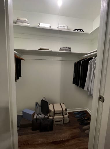 a closet with clothes and luggage on the floor at The Junction, Memphis, TN