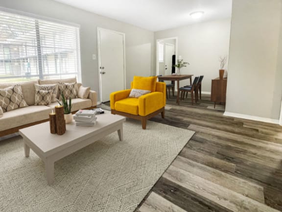 a living room with a yellow chair and a table at The Junction, Tennessee, 38111