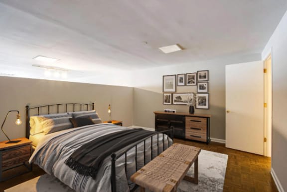 a bedroom with a bed and a dresser and a closet