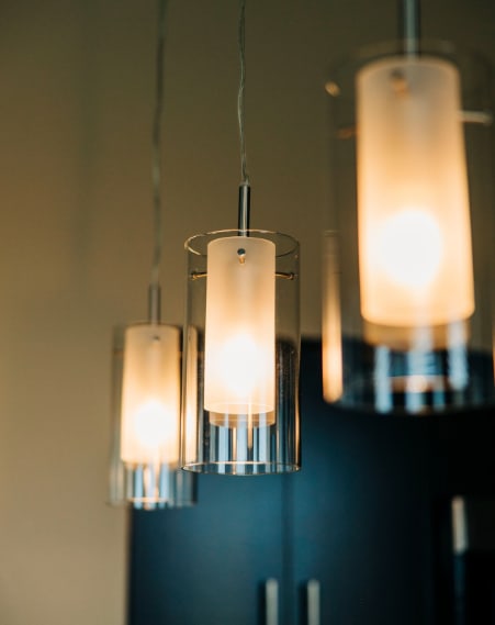 a chandelier filled with lit candles hanging from a wall at Metro67, Memphis, TN