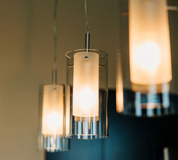 Three hanging lights with a warm glow.