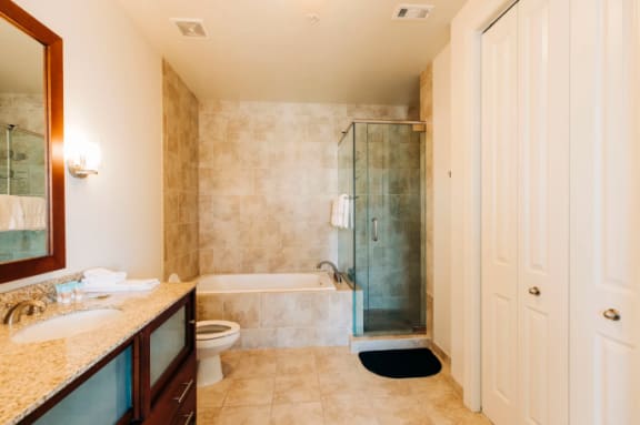 a bathroom with a shower toilet and a sink at Metro67, Memphis, 38103