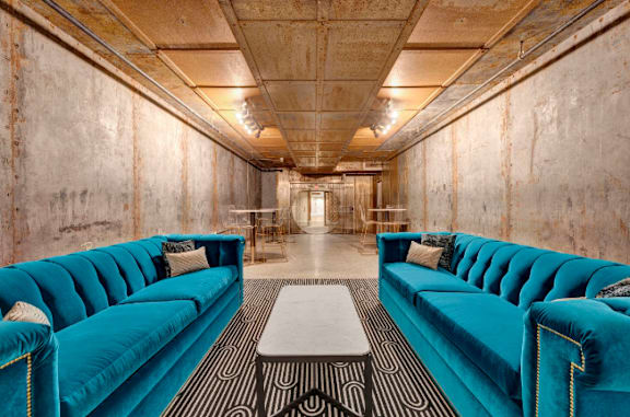 a living room with blue couches and a coffee table at Metro67, Memphis