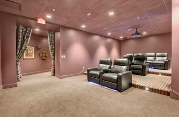 a large screening room with leather chairs and a projector  at Metro67, Memphis, TN