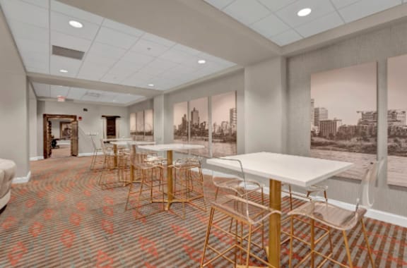 a room with tables and chairs and a wall mural of a city at Metro67, Tennessee, 38103
