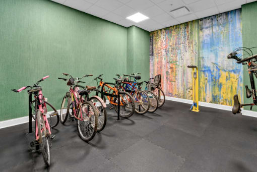 a row of bikes parked in a room with a mural on the wall at Metro67, Memphis, 38103