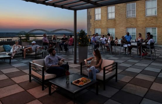 a group of people sitting on chairs on a rooftop patio at Metro67, Memphis, Tennessee