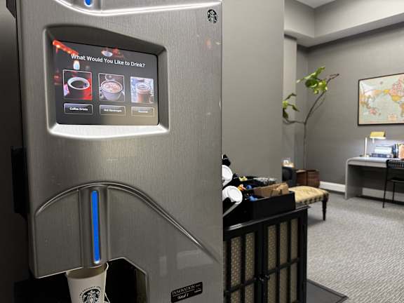 A vending machine with a screen asking