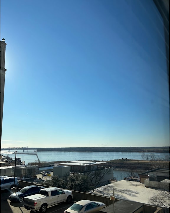 A view of a river from a high vantage point with a clear blue sky.