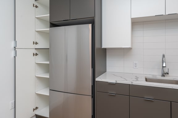 a kitchen with a refrigerator and a sink