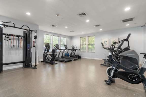A spacious gym with a variety of exercise equipment.