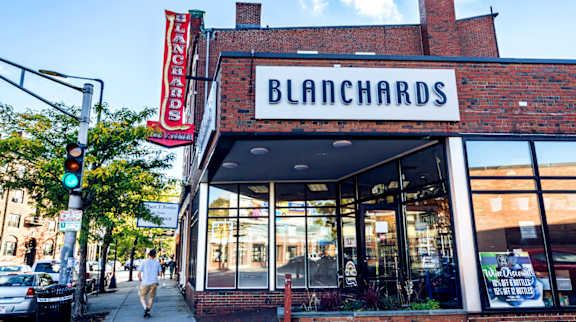 A storefront with a red and white sign that says "BLANCHARDS".