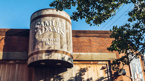 A Samuel Adams Brewery Tour sign is displayed on a building.