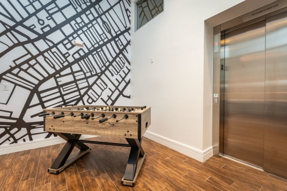 a foosball table in a room with an elevator
