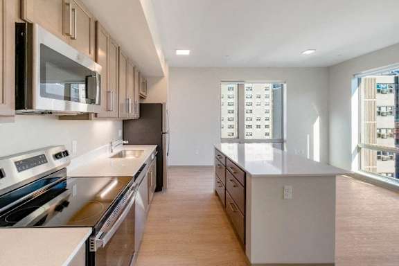 A kitchen with a stove top oven and a microwave at Pok Oi Residences, Boston, MA, Massachusetts, 2111