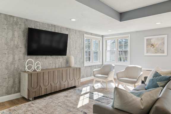 a living room with a couch and a tv on the wall