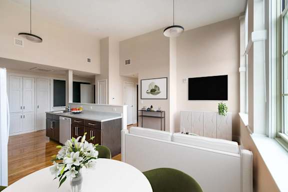 a kitchen and dining room with a white table and chairs at Beverly Village for Living & the Arts Apartments, Beverly, 01915