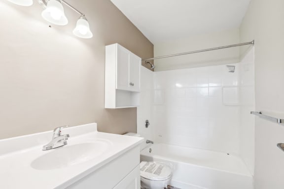 a bathroom with a sink and a tub and a shower at Chapman House, E. Boston