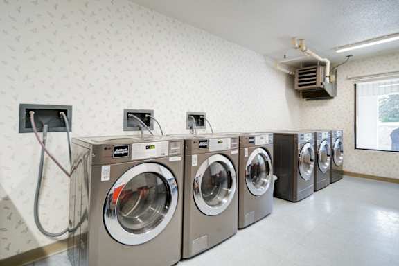 A row of washing machines in a laundromat.