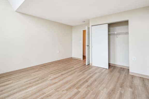 an empty living room with a door to a closet at Chapman House, E. Boston