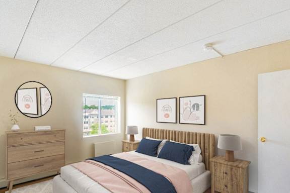 A bedroom with a bed, nightstand, and two framed pictures on the wall	at Edmands House, Framingham, 01701