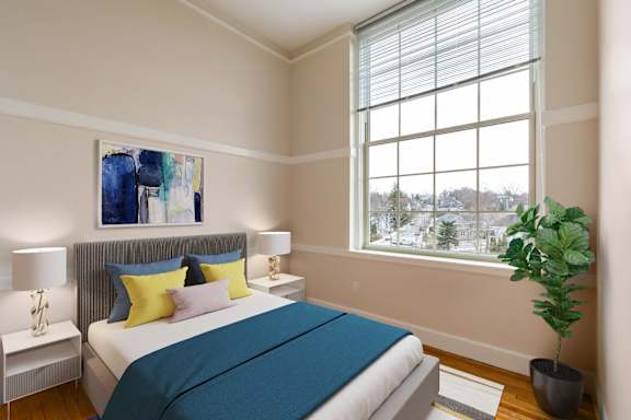 a bedroom with a bed and a large window at Beverly Village for Living & the Arts Apartments, Beverly, 01915