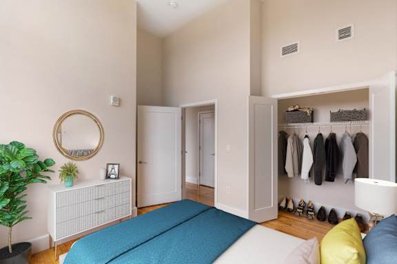 a bedroom with a bed and a closet at Beverly Village for Living & the Arts Apartments, Beverly, 01915
