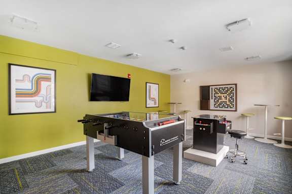a games room with a pool table and a television at Station Pointe, Mansfield, 02048