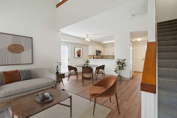 a living room with a couch and a table and a kitchen with a dining room at Mariner's Hill Apartments, Massachusetts