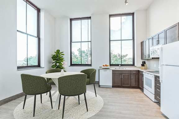 a kitchen and dining area with a table and chairs