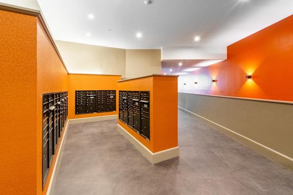 a large wine cellar with orange walls and rows of wine bottles at Beverly Village for Living & the Arts Apartments, Beverly, 01915