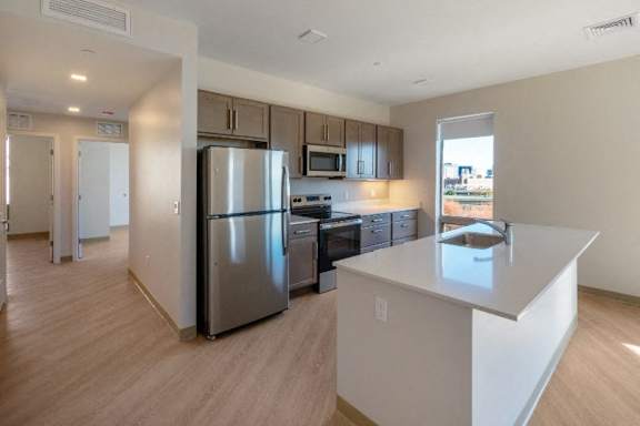 A kitchen with a refrigerator, microwave, oven, and sink at Pok Oi Residences, Boston, MA, Massachusetts, 2111