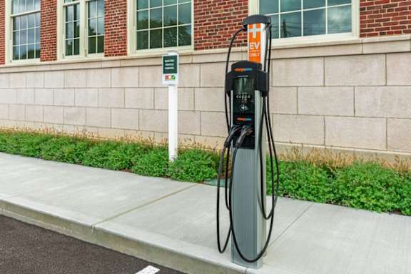 a gas pump on the sidewalk in front of a building at Beverly Village for Living & the Arts Apartments, Beverly, 01915
