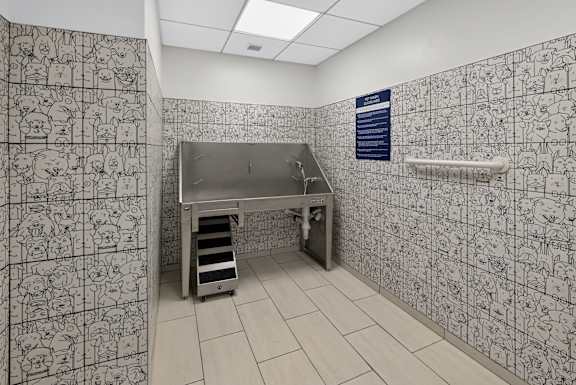 A bathroom with a wallpaper of cartoons.