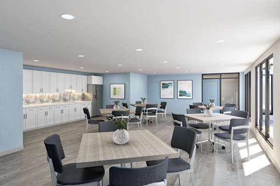 A modern dining room with a long table and chairs.