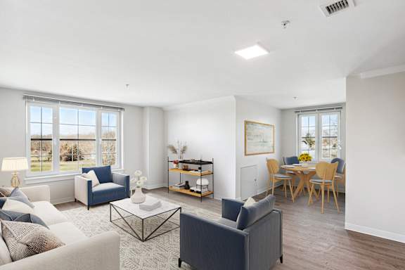 a living room with couches and chairs and a dining room table at Shoreline Grove, Branford, CT