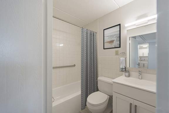a bathroom with a shower and a toilet and a sink