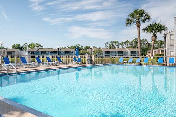 Outdoor swimming pool at Fishermans Landing apartments in Ormond Beach, FL
