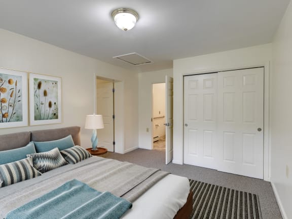 a bedroom with a bed and a closet at Chambers Senior Housing Apartments, Kingston, NY