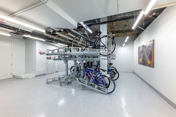 a group of bikes on a rack in a room at 140 Clarendon, Boston, MA