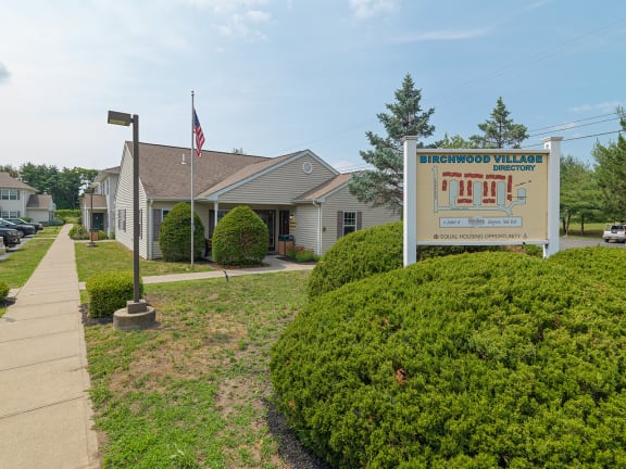 a building with a sign in front of it at Birchwood Village Apartments, Kingston, New York