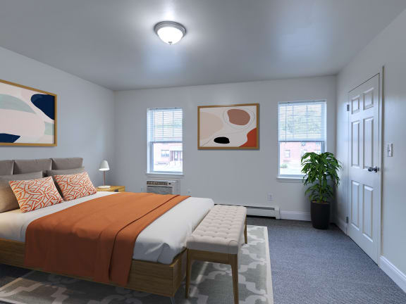 a bedroom with a bed and two windows at Birchwood Village Apartments, Kingston, New York