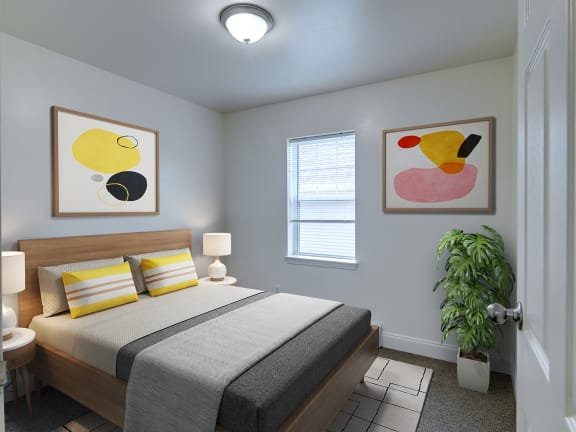 a bedroom with a bed and two paintings on the wall at Birchwood Village Apartments, Kingston, New York