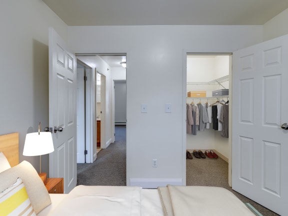 a bedroom with a bed and a closet at Birchwood Village Apartments, Kingston, New York