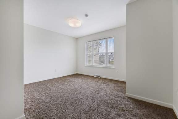 a bedroom with white walls and carpet at Creekwood Apartments, Watertown, 13601